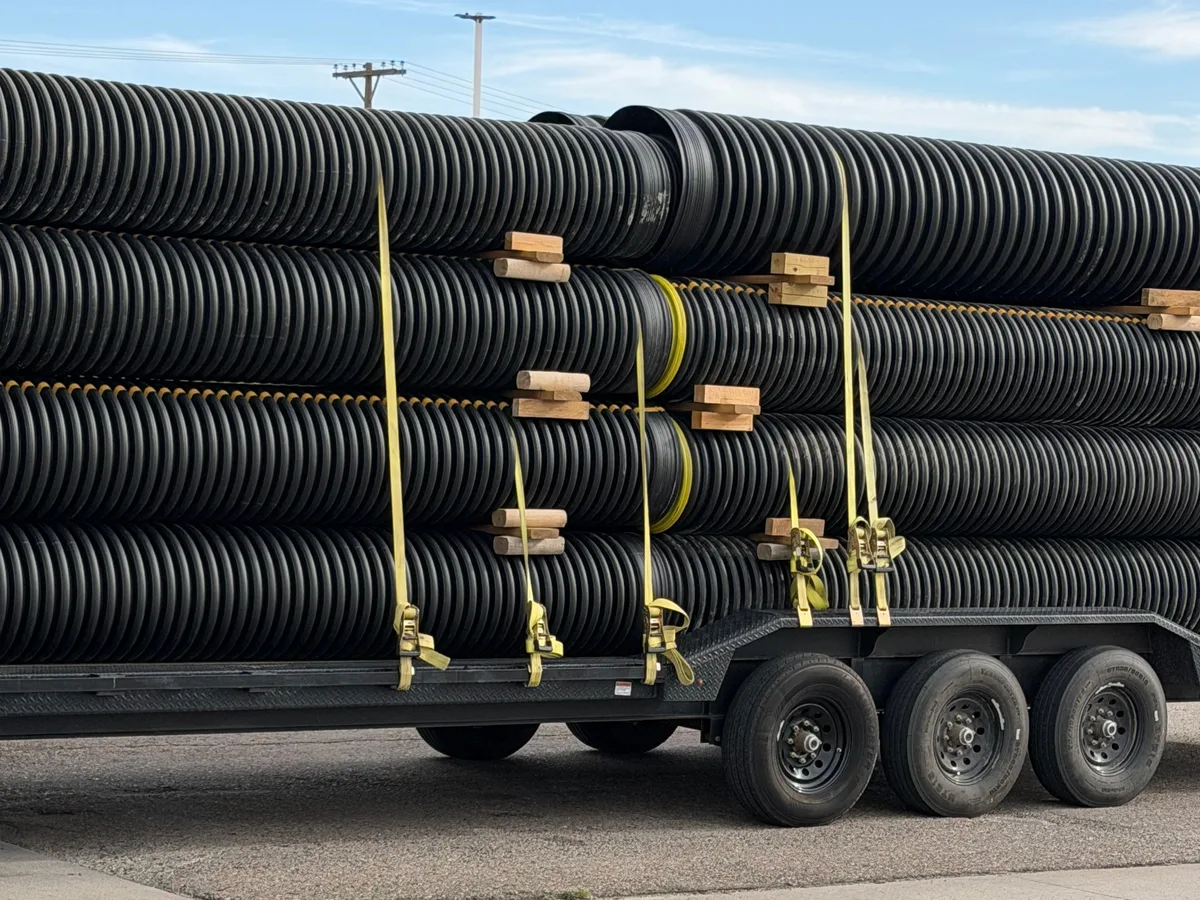 A full trailer of HDPE culvert pipe strapped down for delivery