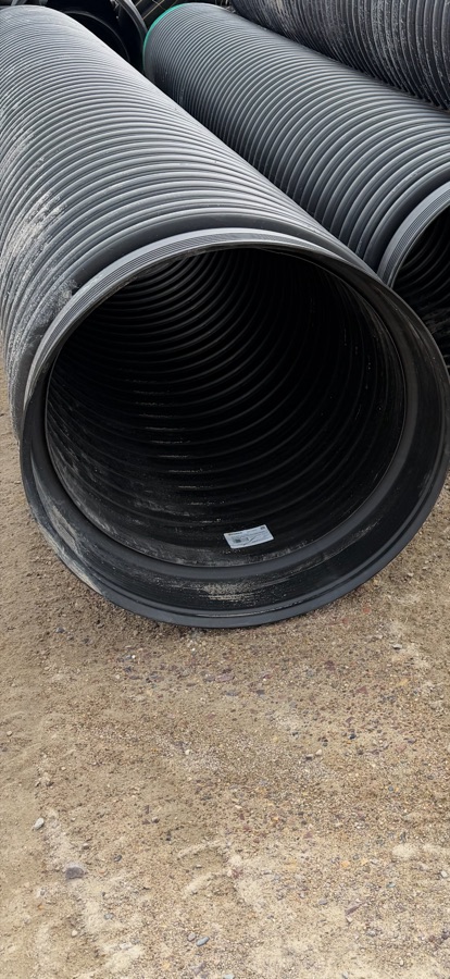 HDPE culvert pipe close-up, corrugated exterior, smooth interior