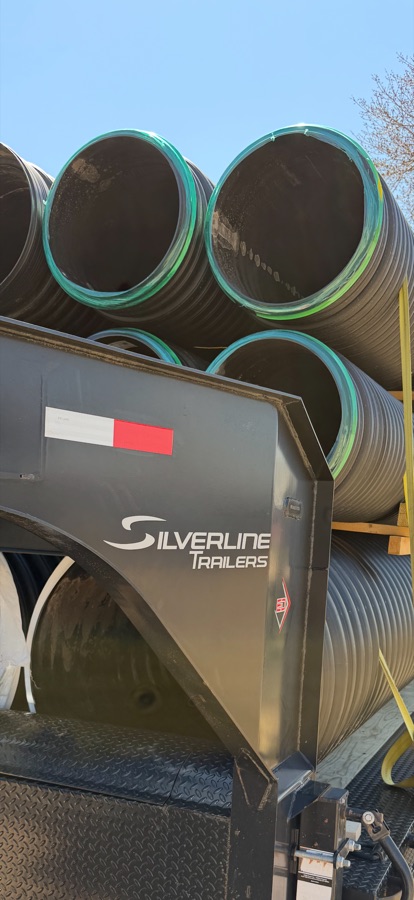 Culvert pipe loaded and strapped on a Swenson Supply trailer