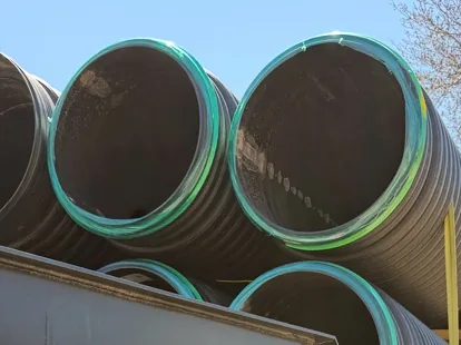 Culvert pipe loaded and strapped on a Swenson Supply trailer